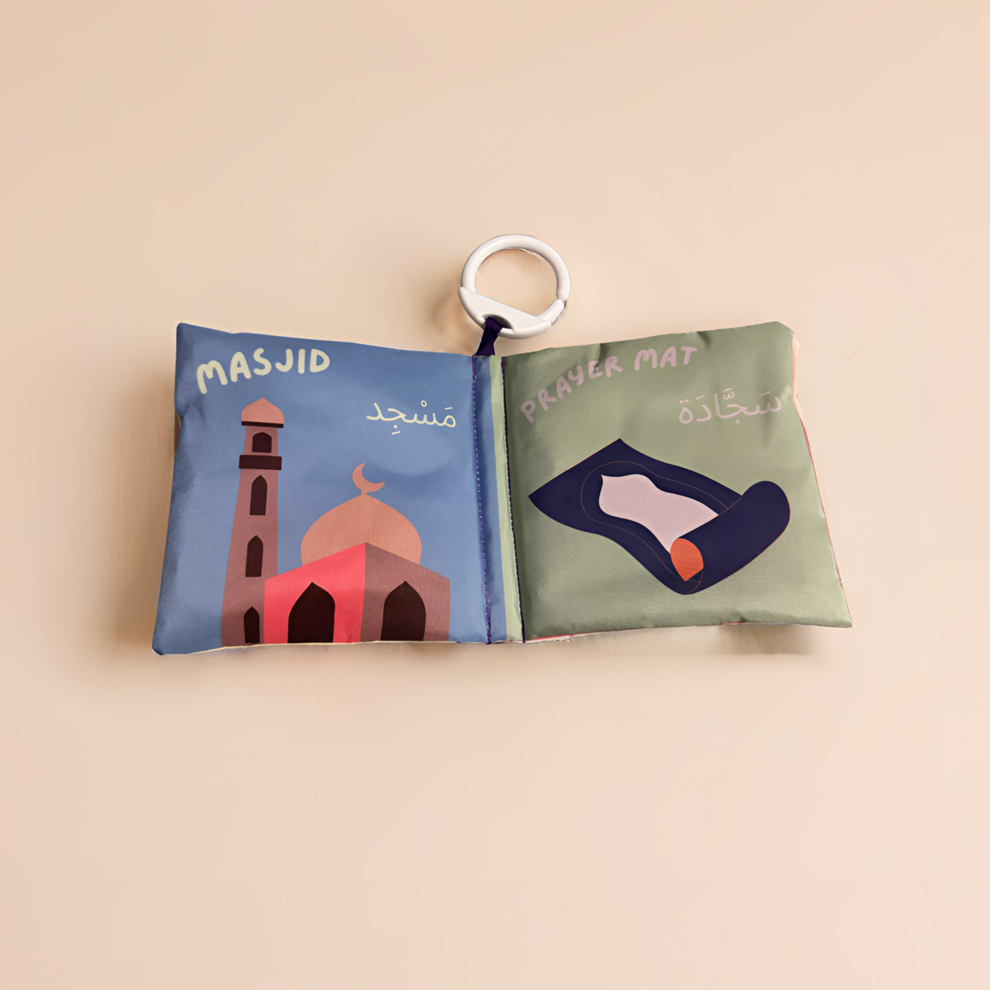 Fabric book with illustrations of a mosque and prayer mat on a beige background